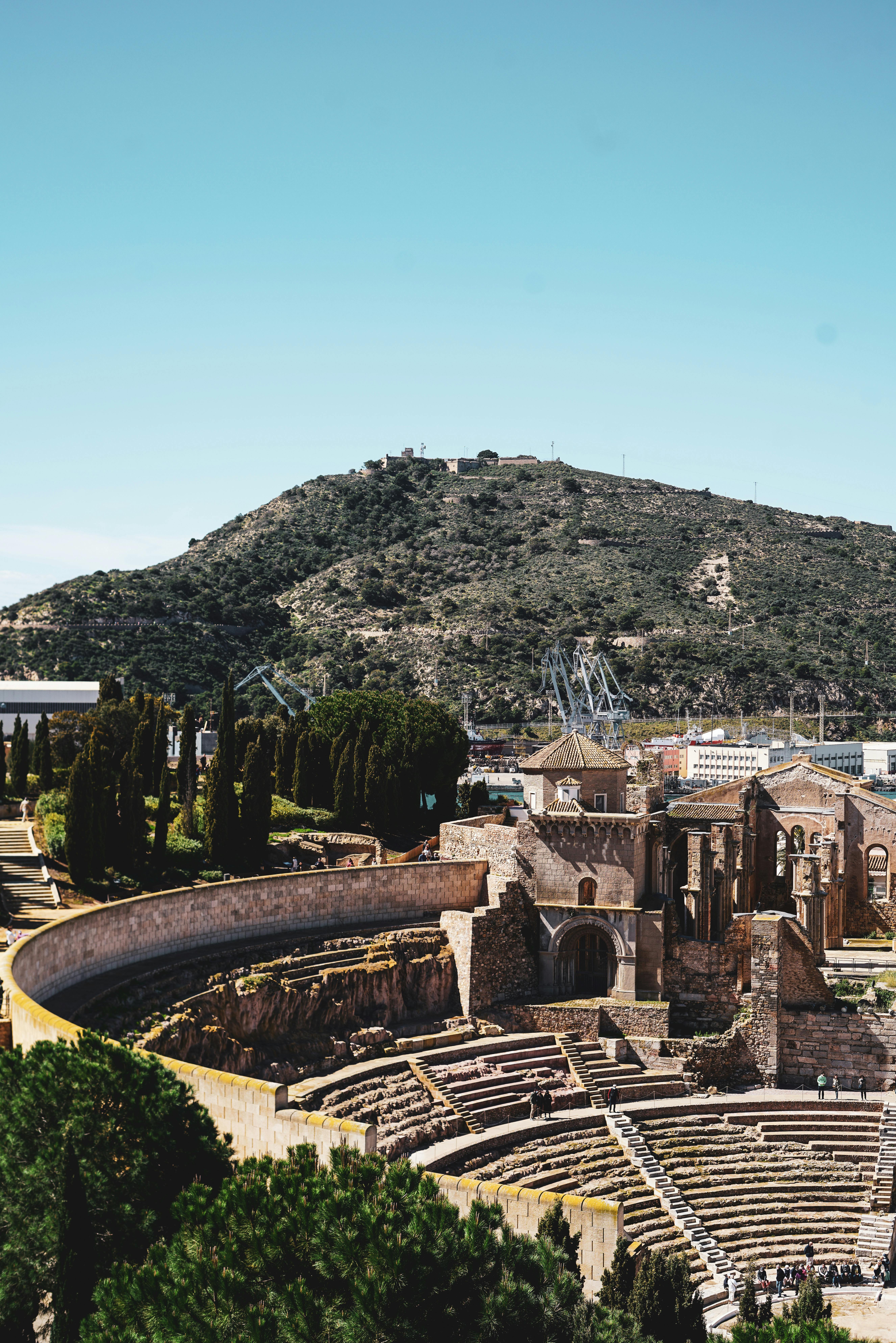 The Roman Theatre in Cartagena with the hillside and port landscape beyond, highlighting the city&rsquo;s Roman and maritime character.